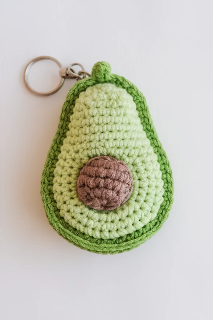 A photo of a crochet avocado keychain th GLACLzexUZ2YbfT5YWt4pg rX9xIVBOQGqPZR6zQm04ng cover